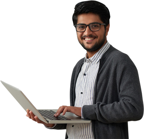 Smiling man dressed in business casual holding a laptop.